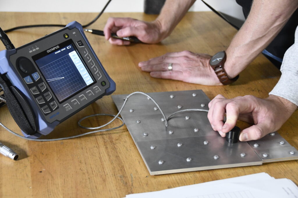 BWXT employees testing measuring penn depth using a scanner device