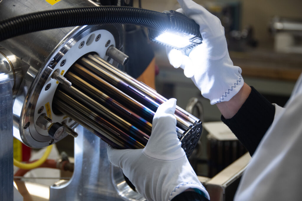 BWXT nuclear fuel bundle inspection white gloves light on the rods