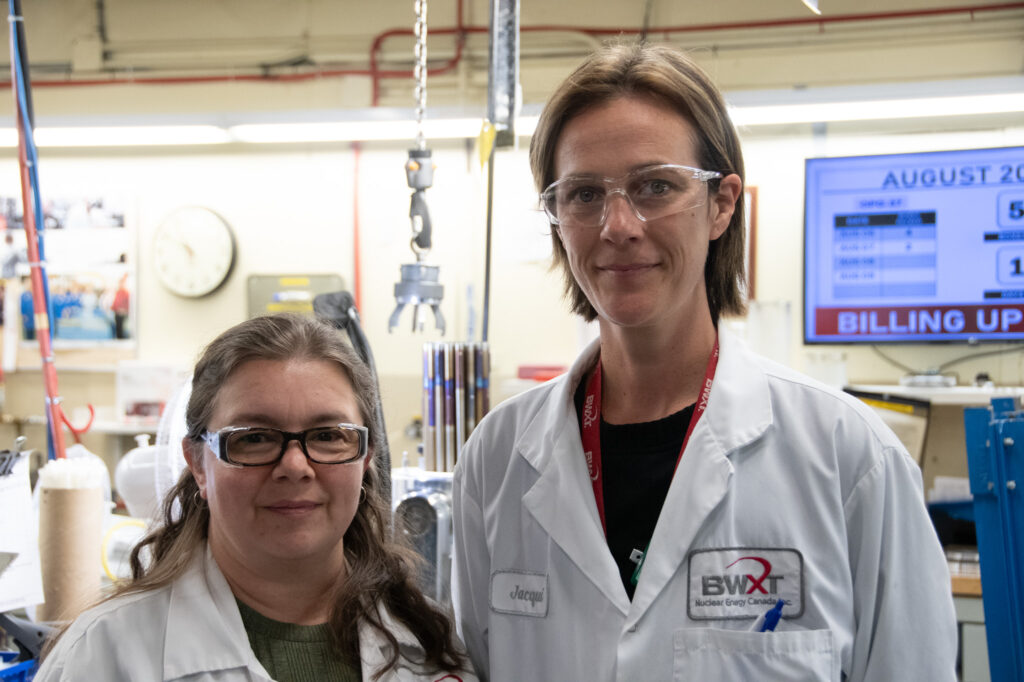 BWXT employees women safety glasses white lab coats